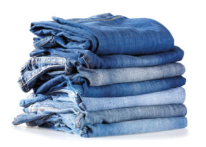 stack of blue jeans isolated on white